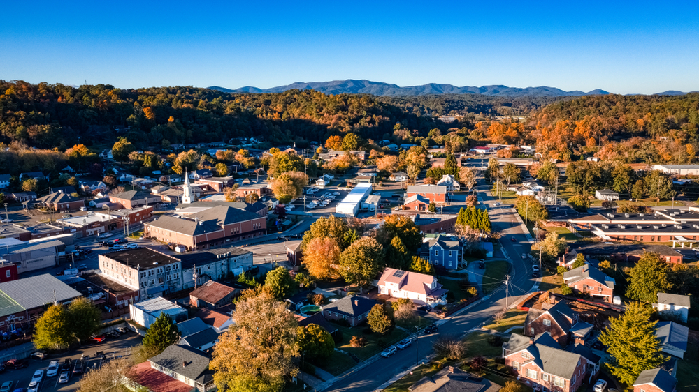 Arial view of Ellijay's downtown area during the fall with leaves starting to change colors during a sunny day 