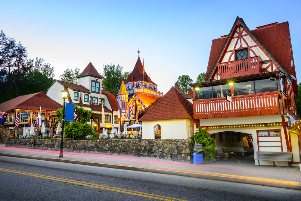 Various buildings structured from German-inspired culture at sunset with one street lamp post in Helen, one of the best small towns in Georgia 