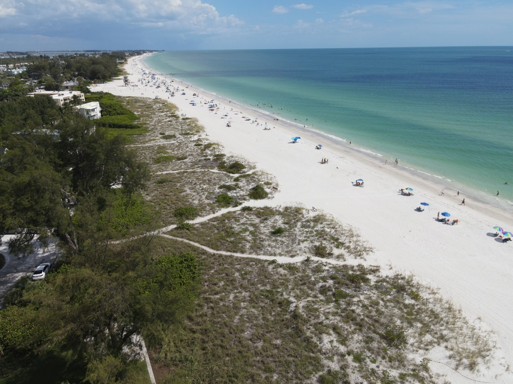 An overhead shot shows the white sands and blue waters of the Preserve of Cortez Beach, which is one of the best things to do in Anna Maria Island