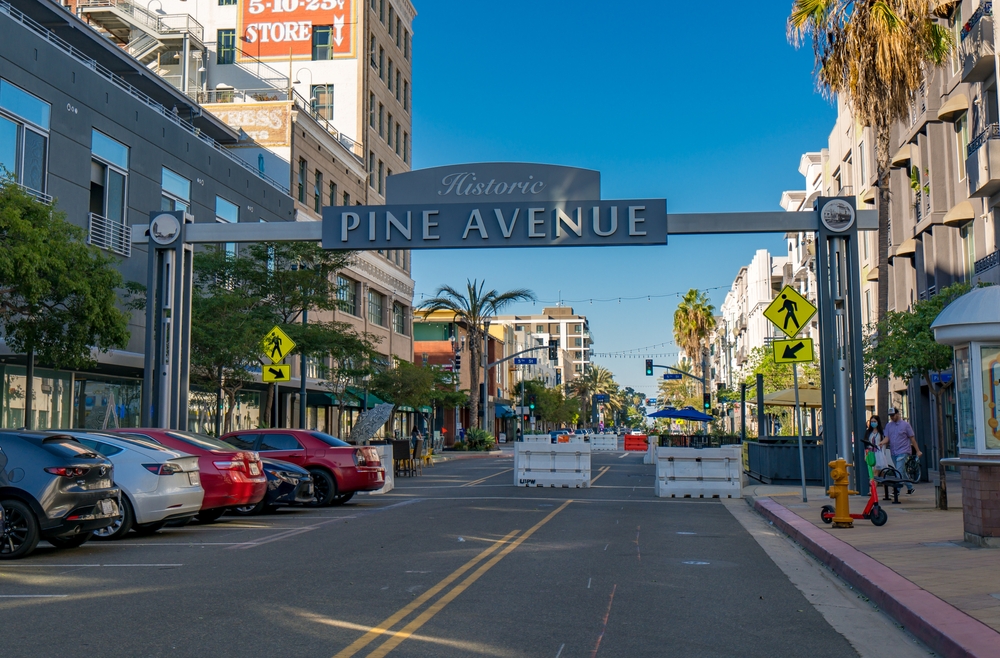 The historic pine avenue sign hangs over the strip in Anna Maria Island: exploring this area, shopping and eating here are things to do in Anna Maria Island!