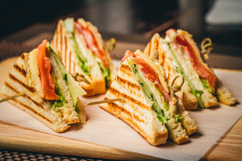 sandwich triangles on a wooden tray in a restaurant in asheville