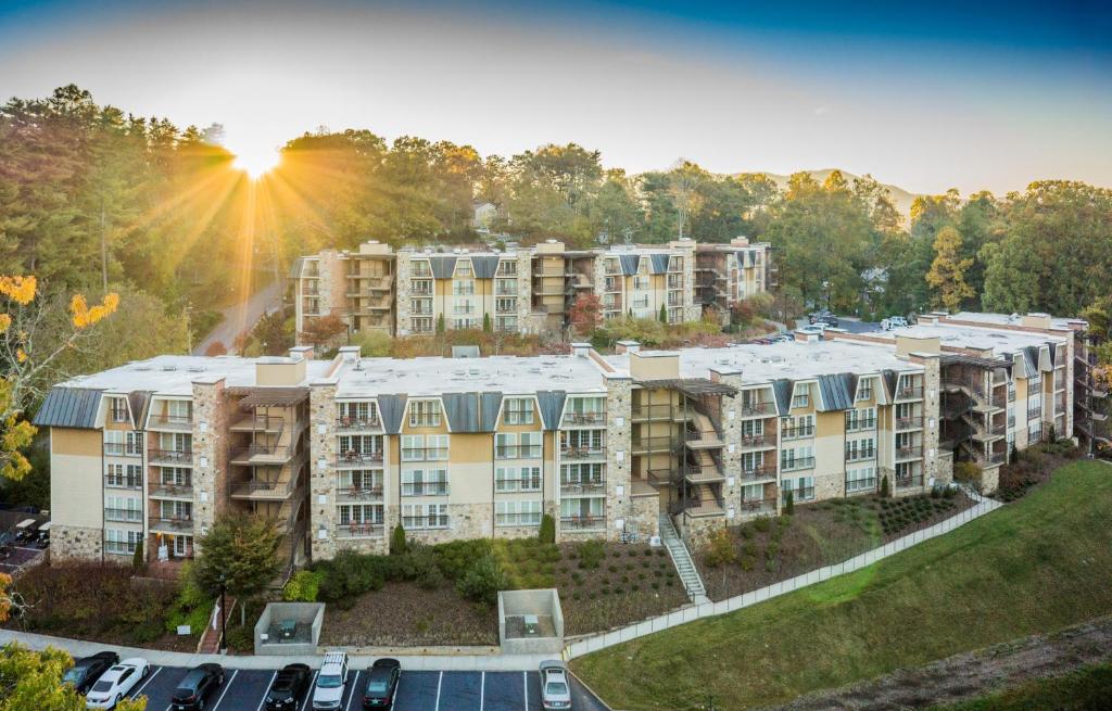 a place to stay during a weekend in Asheville, hotels in middle of picture with trees in the background 