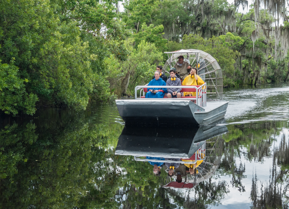 A group of people on an airboat in the Louisana swamp one of the things to do on a weekend in NOLA