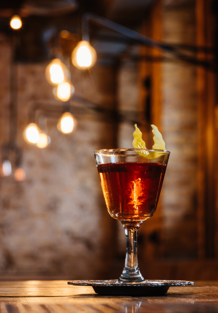 a sazerac cocktail sitting on a bar