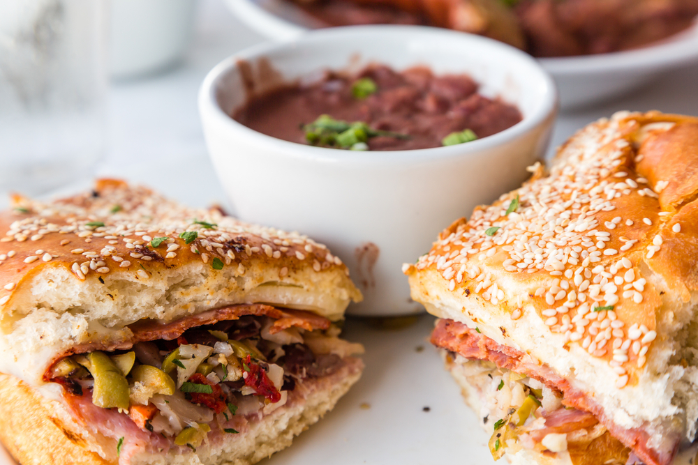 a muffalata sandwich with red beans served at one of the restaurants a must visit when spending a weekend in NOLA
