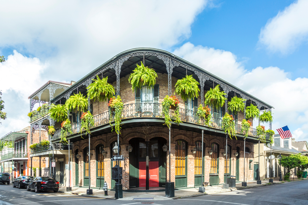 one of the beautiful buildings in the French Quarter decorated with plants hanging off the wrap-around terrace