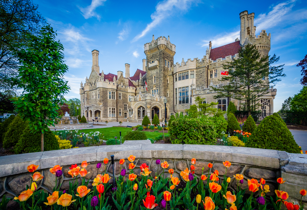 a gorgeous landscaped garden, greenery, trees and tulips decorating the front of this exquisite mansion, the perfect spot to venture on your weekend in Toronto!
