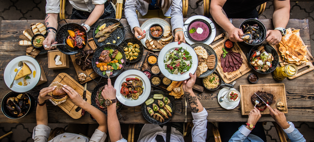 a great, family-style table with veggies, meats and soups all perfect for taste testing on food tours, a great option for a weekend in Toronto!