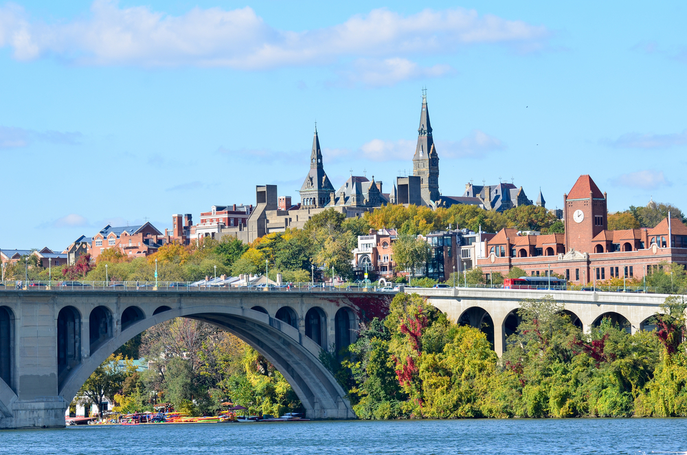 a photo of the Georgetown neighborhood in Washington DC with beautiful old church towers and the iconic bridge 