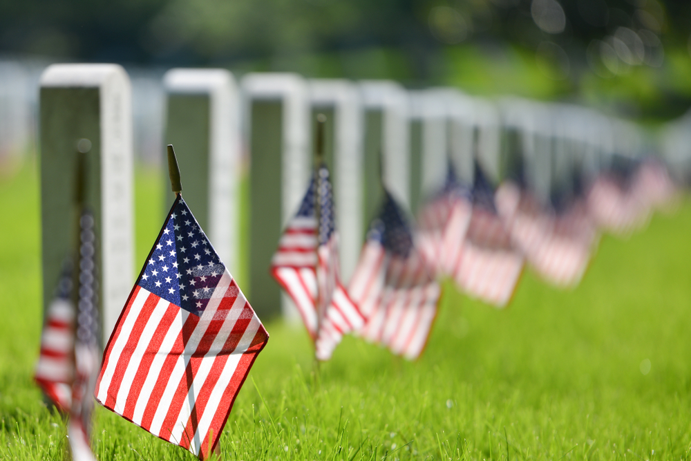 the Arlington National Cemetery with graves and small American flags 