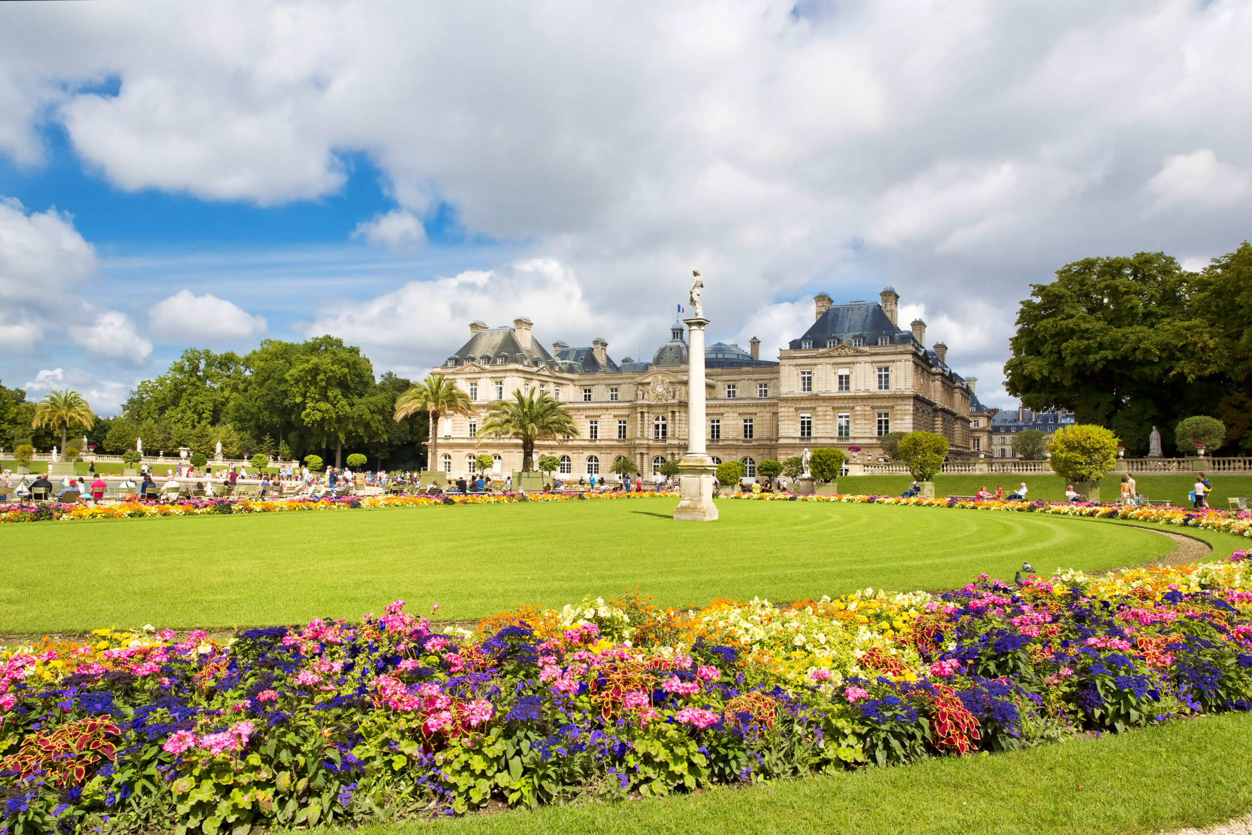 the luxembourg gardens with the castle behind with flowers in the foreground