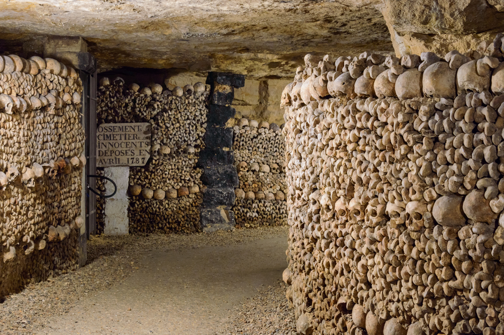 Underground walls made of skulls and bones in the Catacombs.