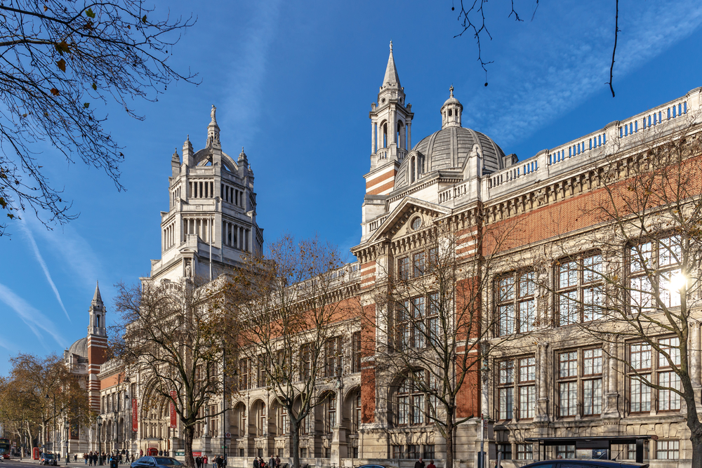 Exterior of the Victoria and Albert  Museum seen through bare trees.