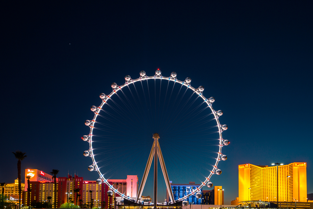 A large ferris wheel all lit up at night in Las Vegas