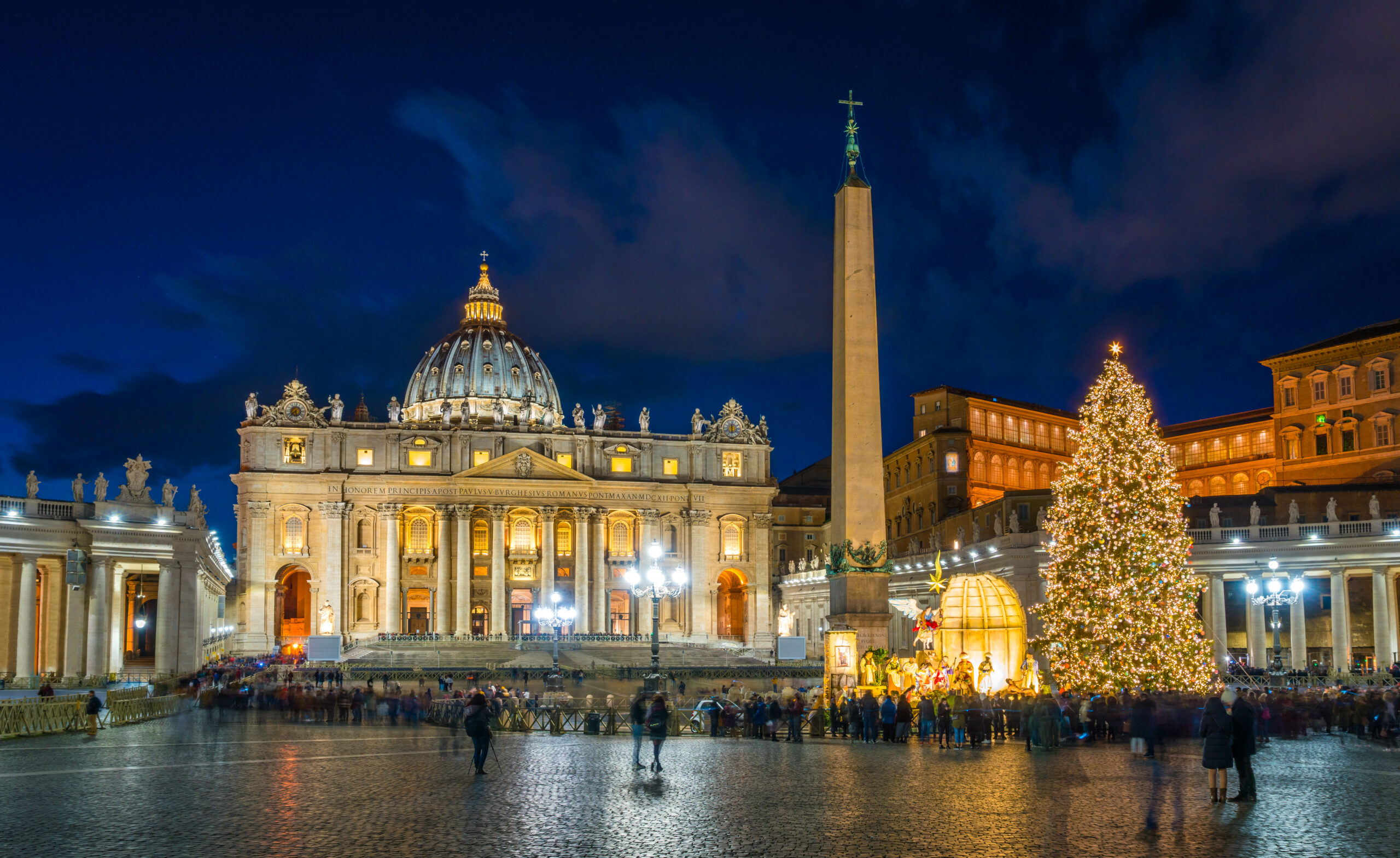 A huge christmas tree and christmas display outside St. Peter's Basilica. 