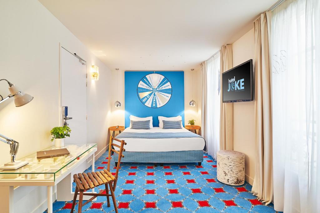 a brightly colored blue room with htoel joke with bright carpet and modern rooms