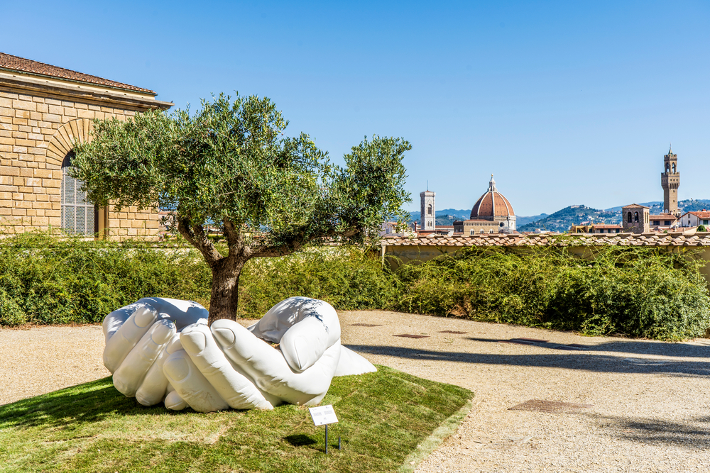 Sculpture of hands holding a small tree in Boboli Gardens in Florence.