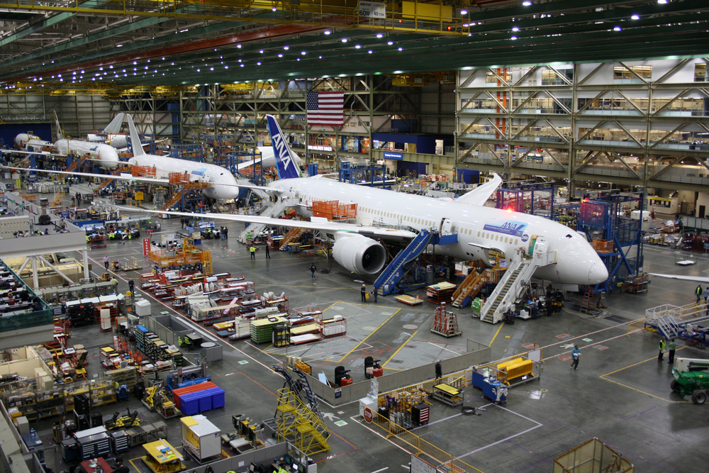 Multiple Boeing planes in a factory.