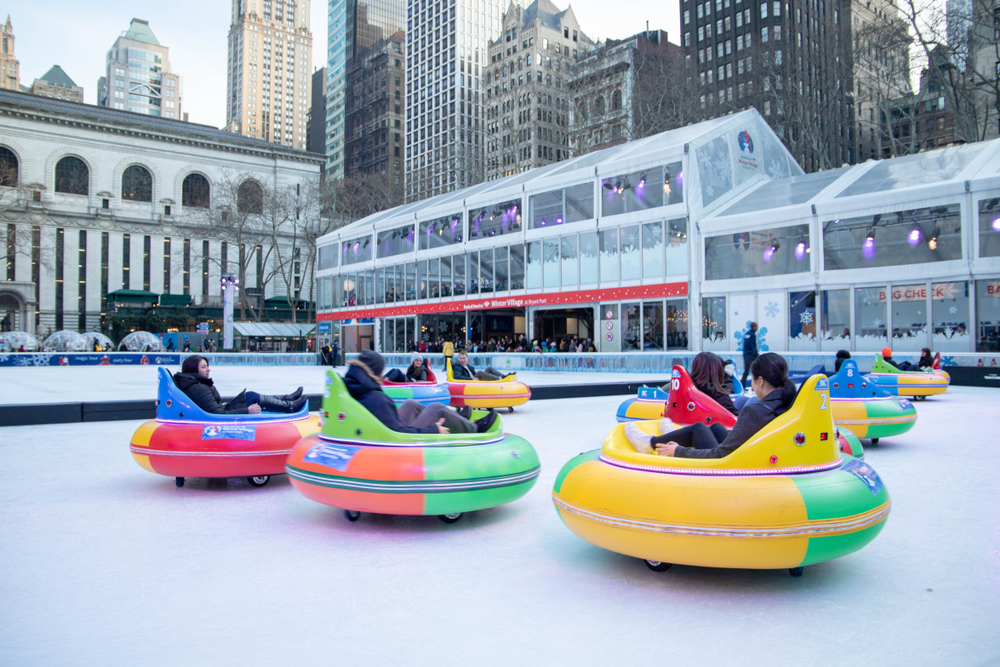 Colorful bumper cars shaped like tubes on an ice rink in New York in winter.