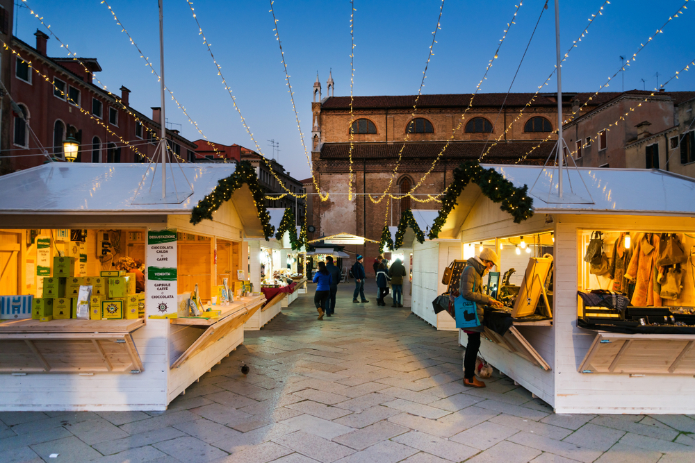 People browsing stalls at a Christmas market in Campo San Stefano.