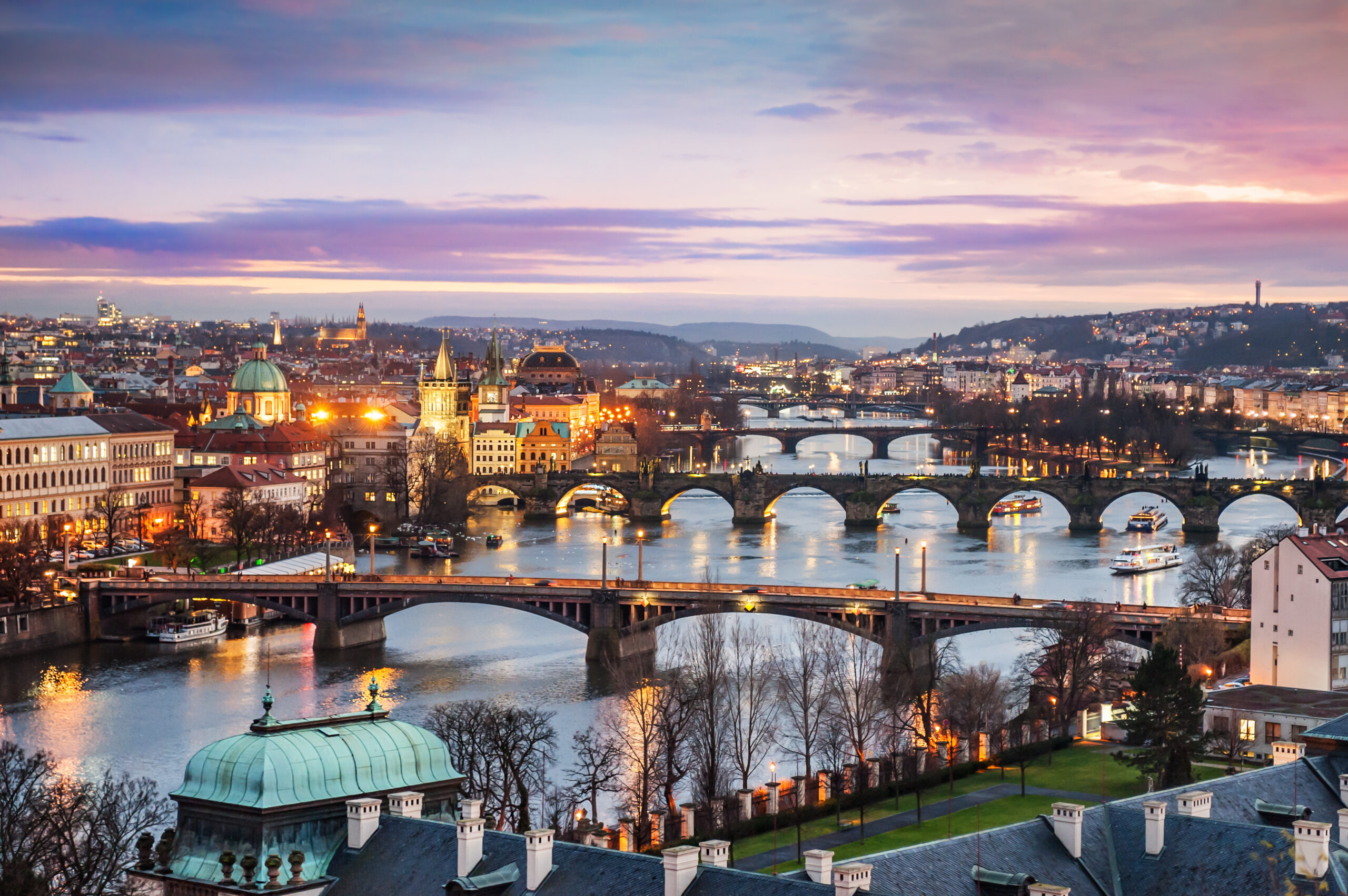 Beautiful view of a purpley winter sunset over the bridges and rivers of Prague 