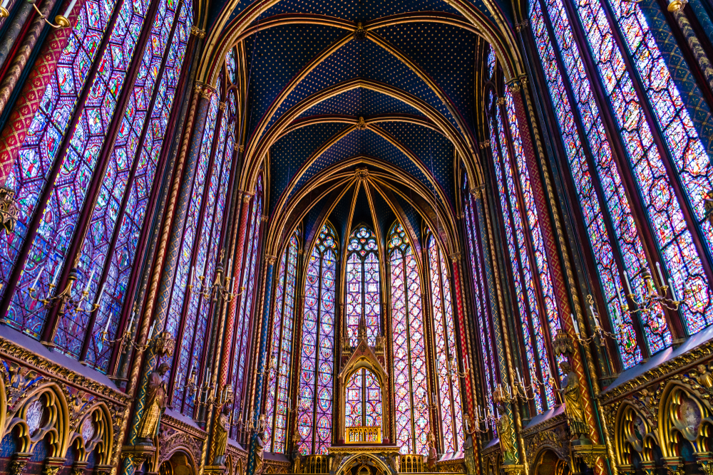 Beautiful, tall purple stained glass windows and an arched ceiling in Sainte Chapelle.