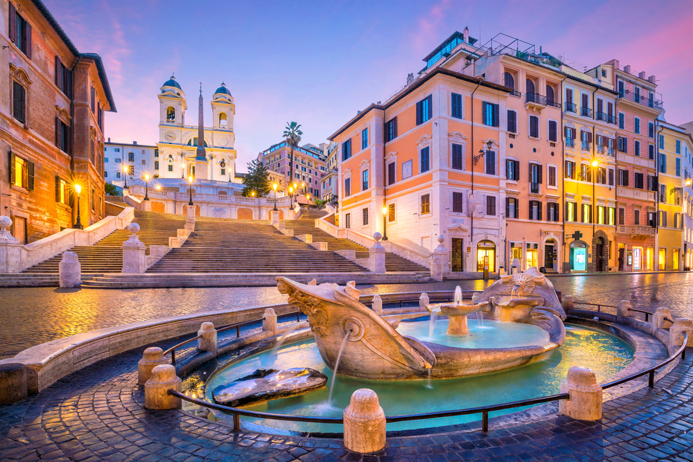 Pink sunset over the Spanish Steps and a fountain in Rome during 10 days in Italy itinerary.