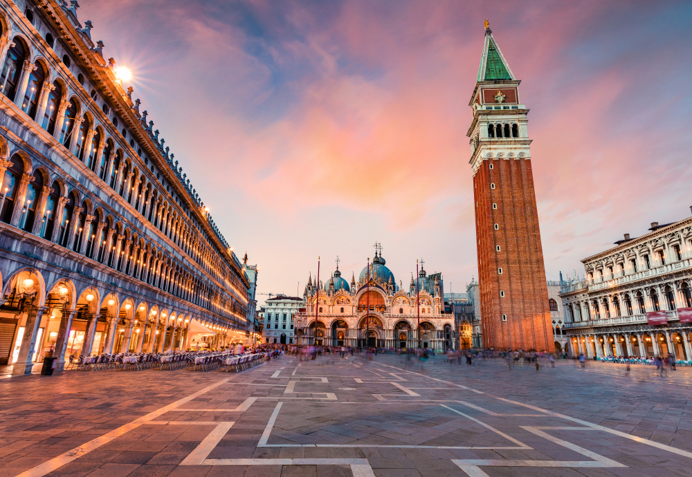 Vivid sunset over St. Mark's Square featuring St Mark's Campanile and Basilica.