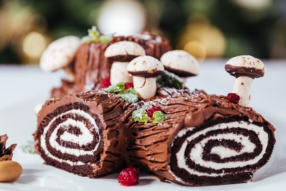 A bûche de Noël designed to look like a log with mushrooms on it.