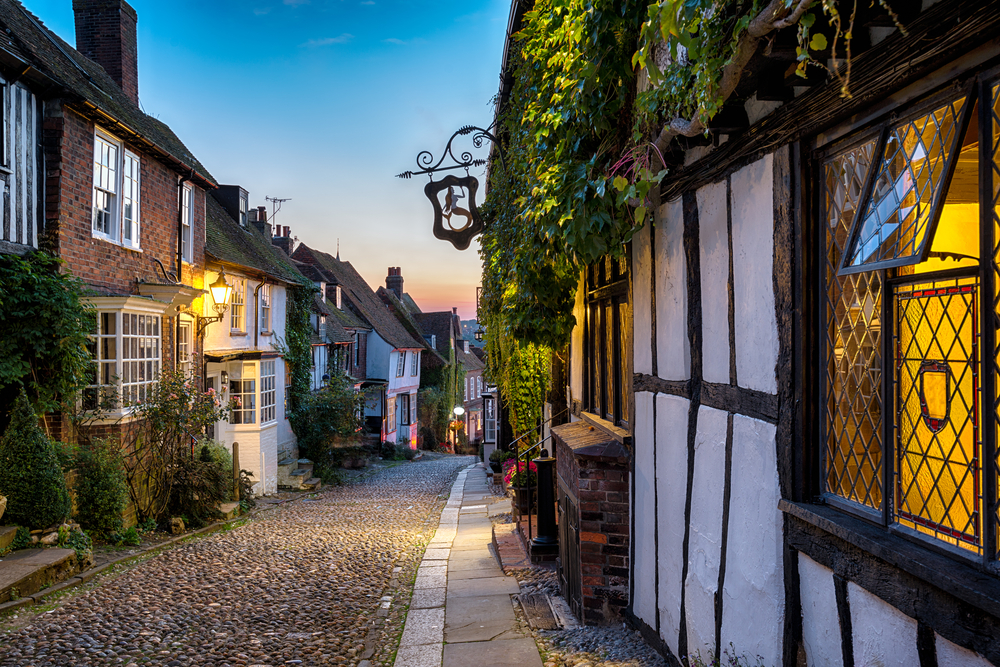 Dusk at a row of beautiful old houses on a cobbled street in one of the english villages.
