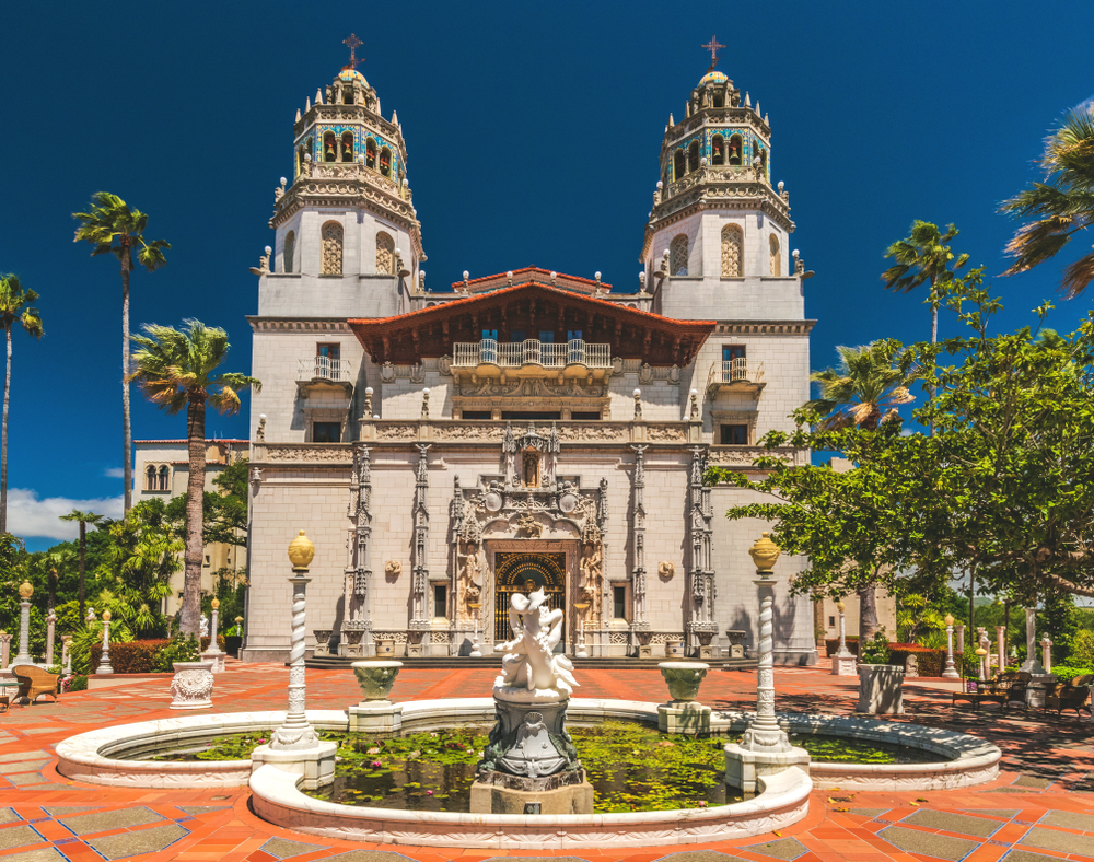 Exterior view of Hearst Castle, William Randolph Hearst's extravagant coastal hilltop estate. The picture shows the exterior with a pond and fountains.  