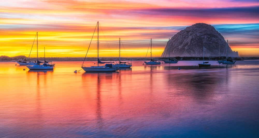 ojai harbor during sunset with rock and boats