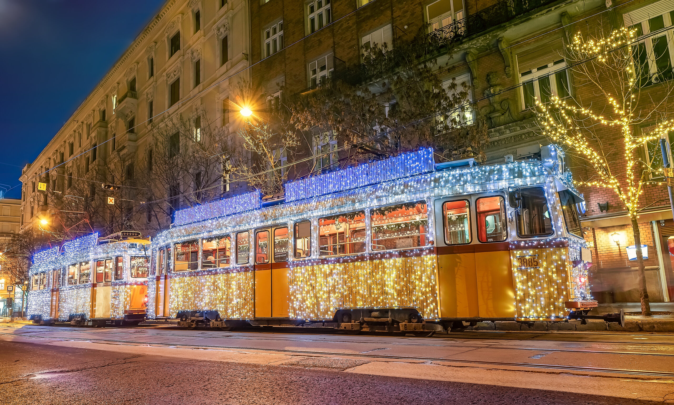View of a Budapest christmas tram covered in festive fairy lights. 