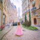 woman standing in a pink skirt and looking at the Eiffel Tower in the background