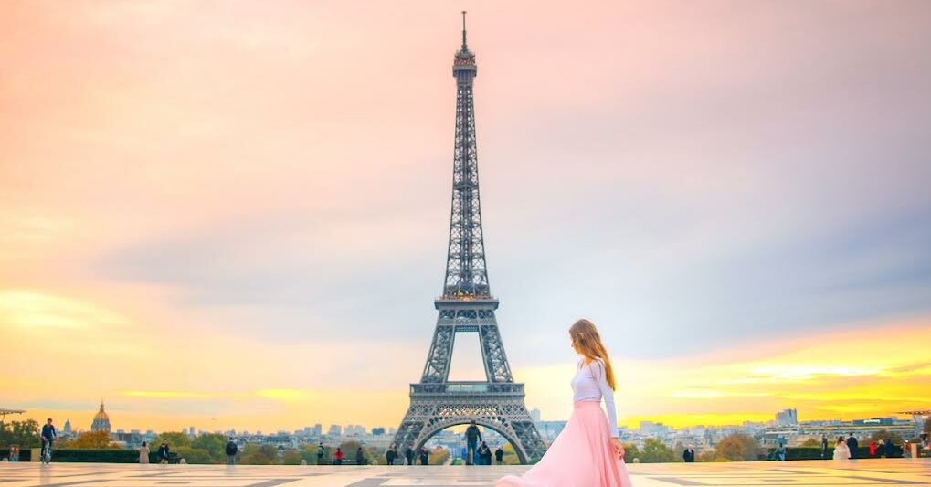a girl in pink skirt on steps of Trocadeo Plaza in Paris