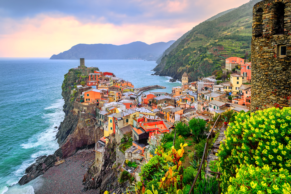 Sunset over a colorful, cliff side town in Cinque Terre.