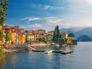 beautiful homes and houses in lake como in nothern italy with trees and a lake in the foreground