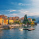 beautiful homes and houses in lake como in nothern italy with trees and a lake in the foreground