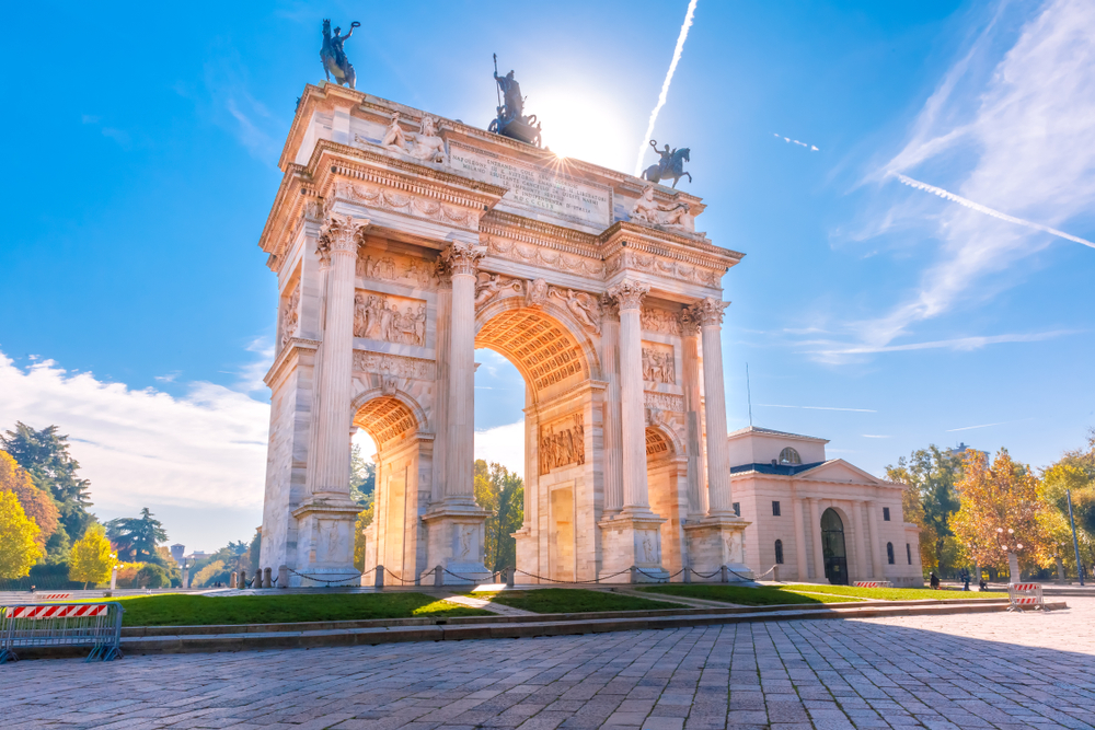 Sunny day over the Arch of Peace with statues on top in Milan.