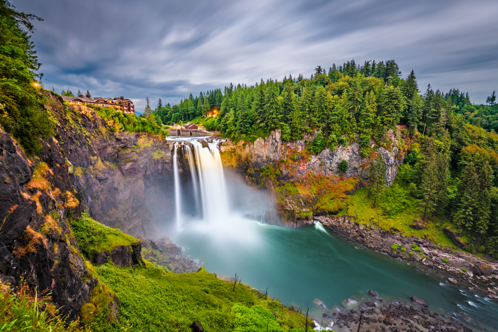 Long exposure photo of Snoqualmie Falls cascading from a cliff on a cloudy day.