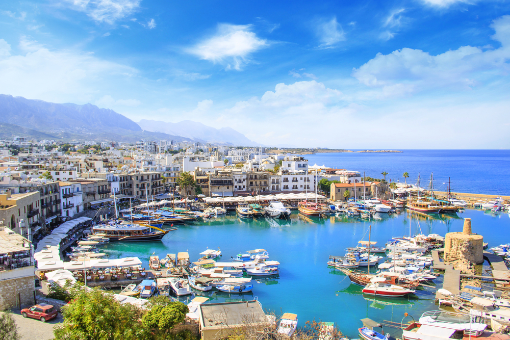 top place to visit in europe, a curved marina sits in front of a town in cyprus