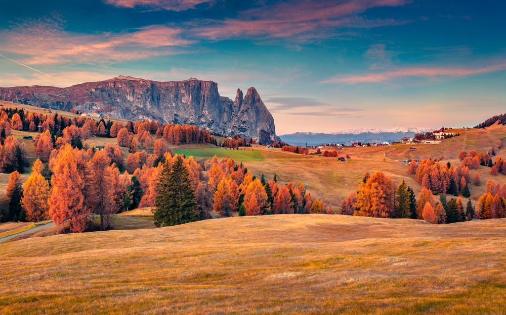 Colorful autumn view of Alpe di Siusi ski resort with beautiful orange larch trees. Majestic sunrise in Dolomite Alps, Ortisei locattion, Italy, Europe