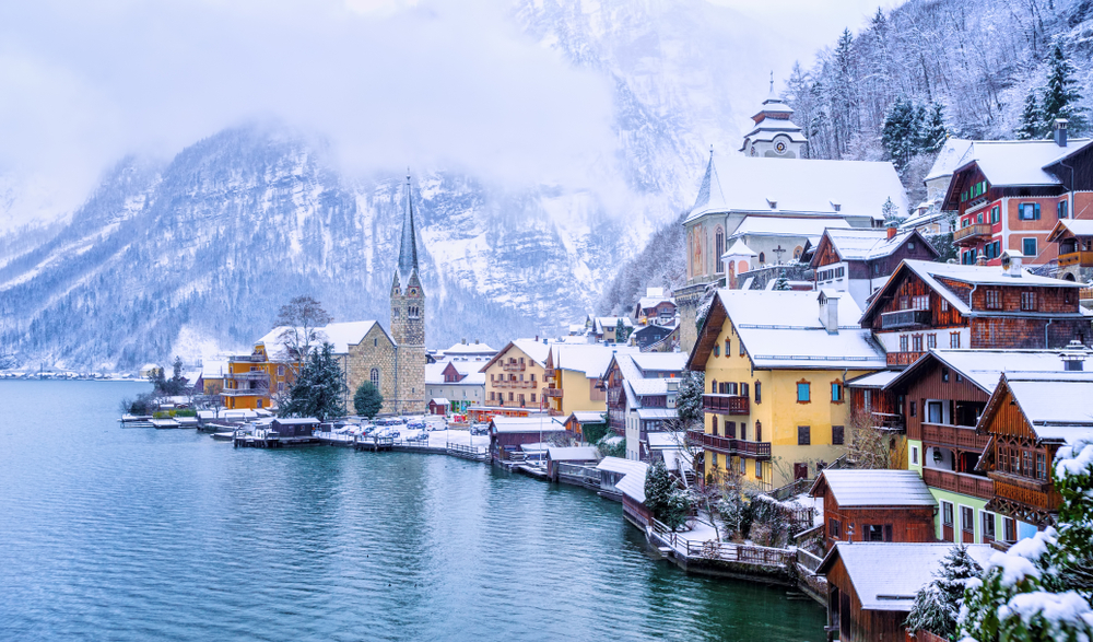 Historical Hallstatt town on a lake in Alps mountains, Austria, snow covered in winter time. 