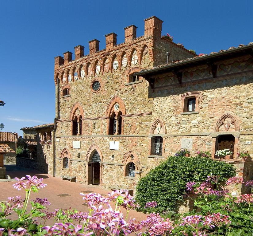 Close up of a castle with flowers at the front. 