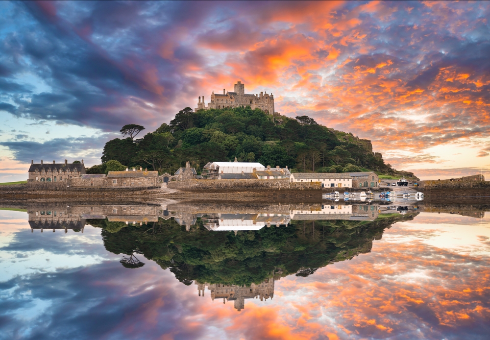 St Michaels Mount at sunrise. The island is perfectly reflected in the water. One of the places in southern england 