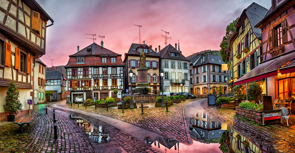 Rainy sunset in historical village Ribeauville. There are paths with houses around,