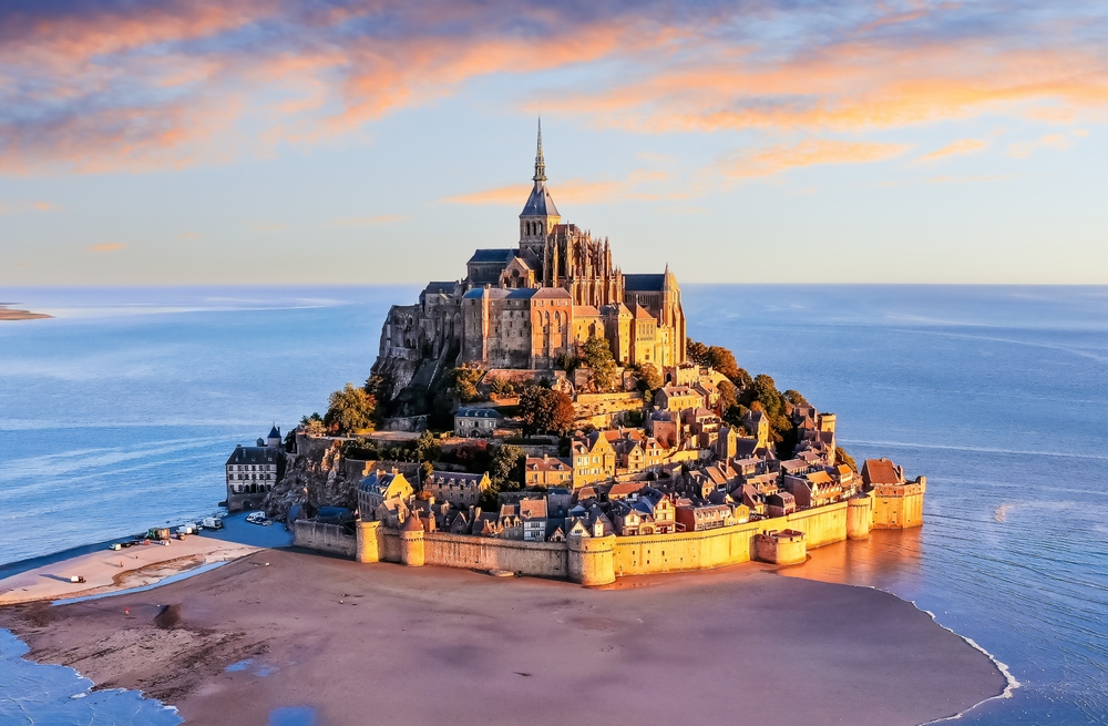Mont Saint-Michel. Aerial view from the southeast during sunrise.