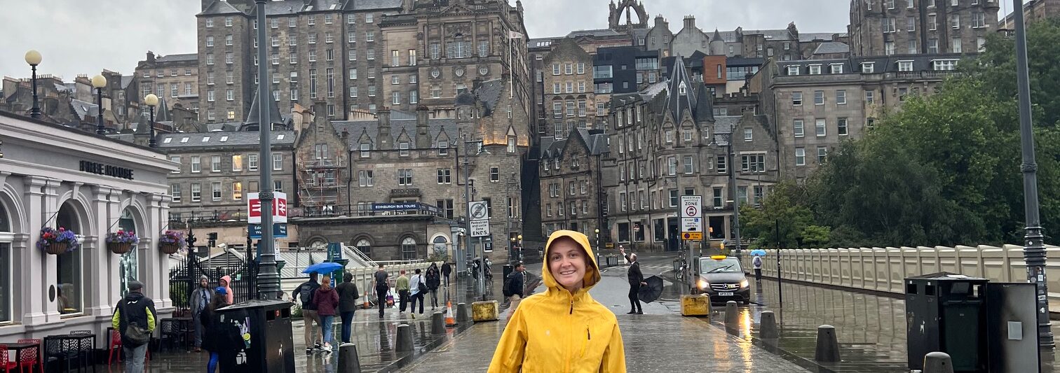 a girl in yelow jacket standing on waverley bridge