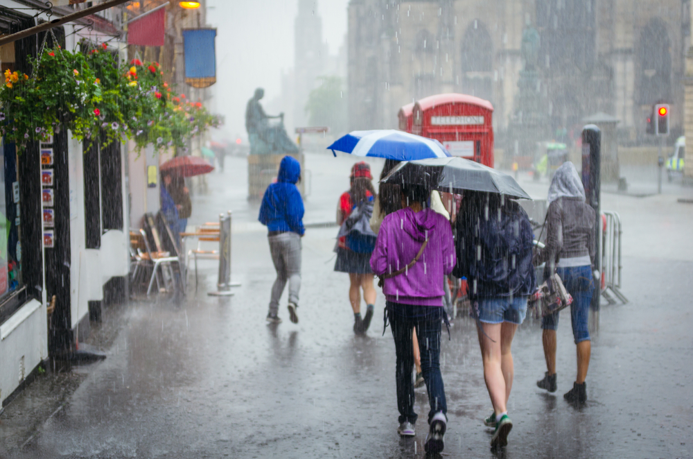 a rainy day in London with people holding umbrellas