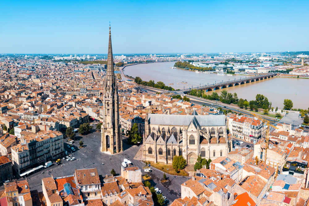 Aerial view of Bordeaux featuring a church and the river on a France road trip.